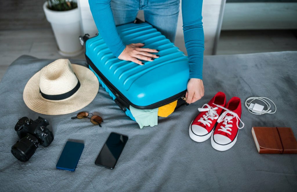 Woman packing luggage for vacation