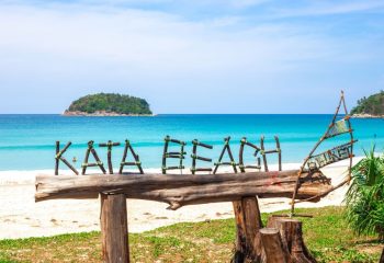 Tropical beach in Thailand, on the island of Phuket, the inscription - Kata beach from tree branches.